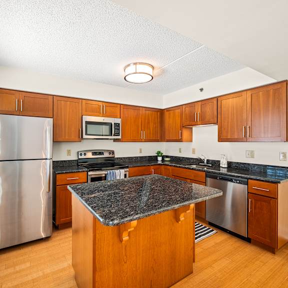 a kitchen with wooden cabinets and a granite counter top.