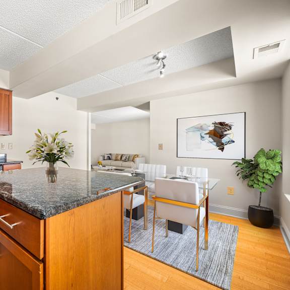 a kitchen with a black granite countertop and wooden cabinets.