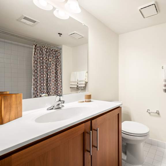 a bathroom with a white sink and a white toilet.