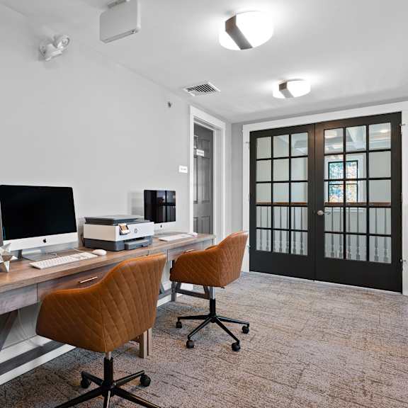 imac computers available in the coworking space at claremont apartments in exton, pa, providing convenience for residents