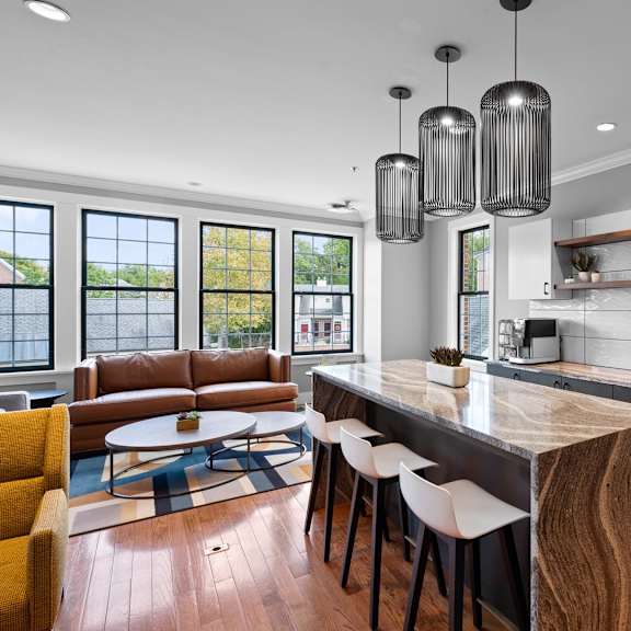 a modern kitchen with a wooden island and white cabinets.