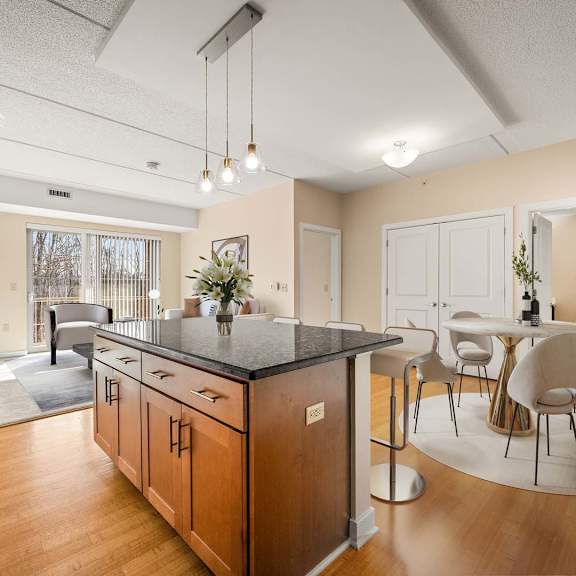 a kitchen with wooden cabinets and a black countertop.