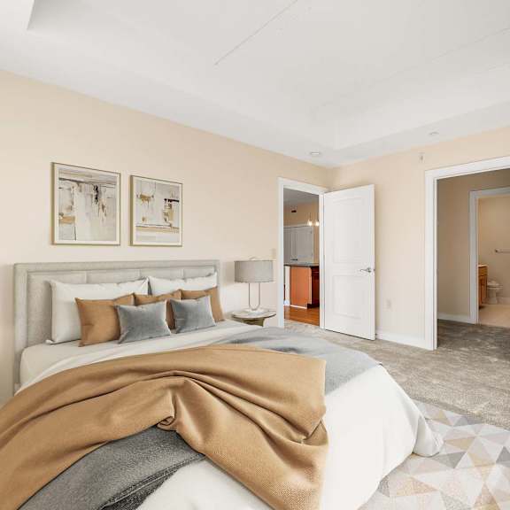 a bedroom with a large bed and a brown blanket.