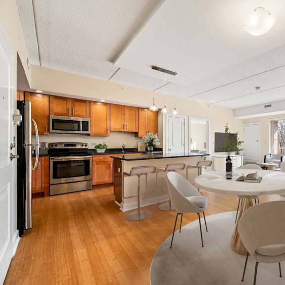 a modern kitchen with a dining table and chairs.