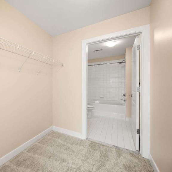 a small room with a white door leading to a bathroom.