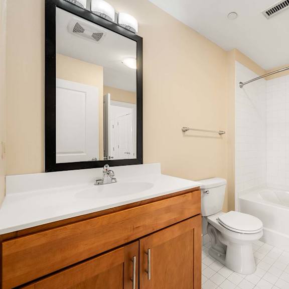 a bathroom with a white sink, toilet, and bathtub.
