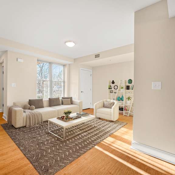 a living room with a white couch and a coffee table.
