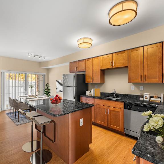 a kitchen with wooden cabinets and a black countertop.