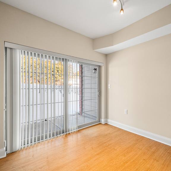 a room with a sliding door leading to a balcony.