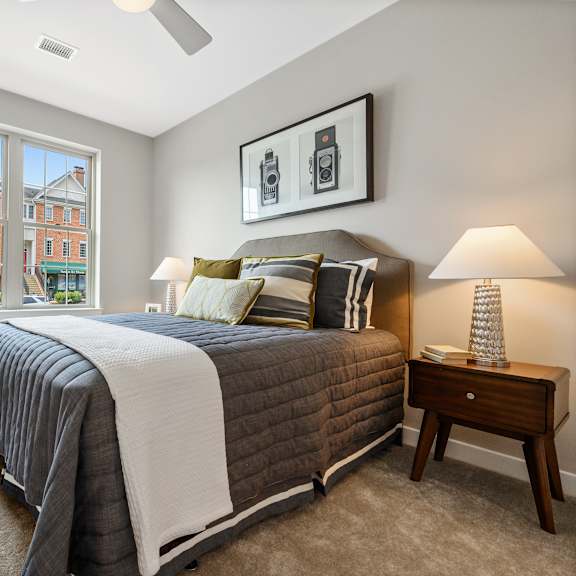 a bedroom with a large bed and a window overlooking a building.