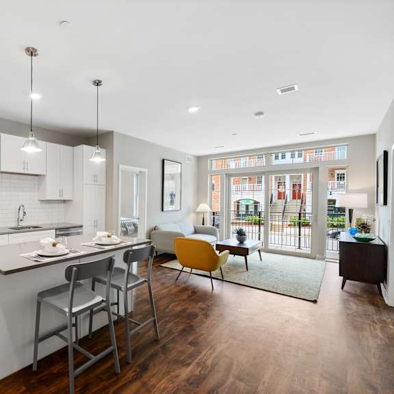 a modern kitchen with a large island and a view of the backyard.