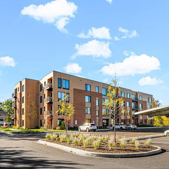 the building housing the hotel, featuring modern architecture and a welcoming exterior