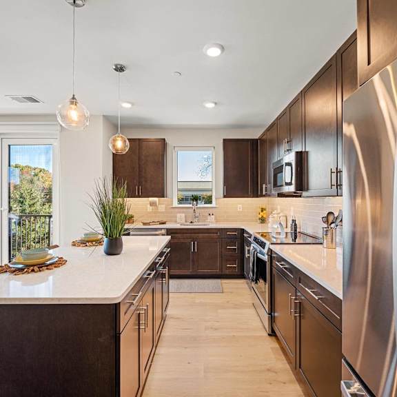 spacious kitchen with sleek wooden cabinetry, stainless steel appliances, and granite countertops at hamilton at eagleview in exton, pa