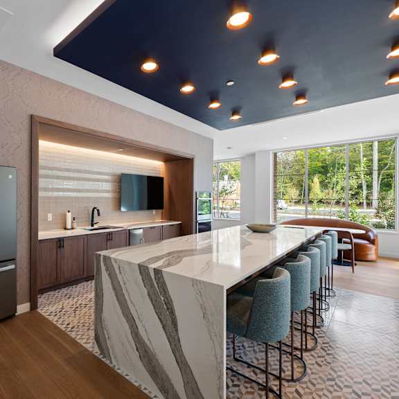 entertainment-ready kitchen with a large island and double-door refrigerator at hamilton at eagleview, exton, pa
