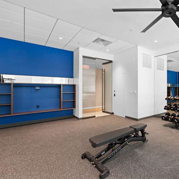 well-equipped fitness area featuring free weights and a large fan for added comfort at hamilton at eagleview, exton, pa 19341.