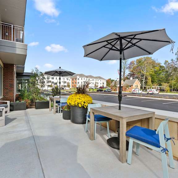 our apartments offer expansive patios with tables, chairs, and umbrellas for outdoor comfort at hamilton at eagleview, exton, pa