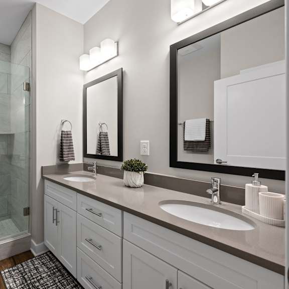 spacious bathroom with double sinks and a glass shower at hamilton at eagleview, exton, pa