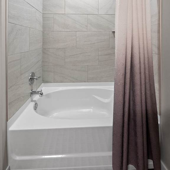bathroom featuring a combination shower and tub with a shower curtain at hamilton at eagleview, exton, pa