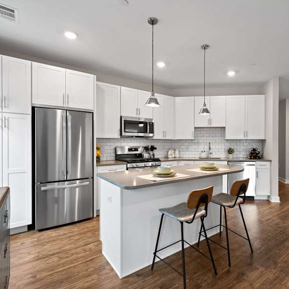 spacious kitchen with white cabinetry, stainless steel appliances, and modern finishes at hamilton at eagleview in exton, pa