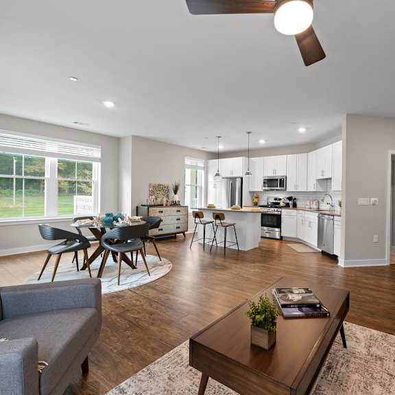 cozy living room with a comfortable couch, stylish table, and modern finishes at hamilton at eagleview, exton, pa 19341