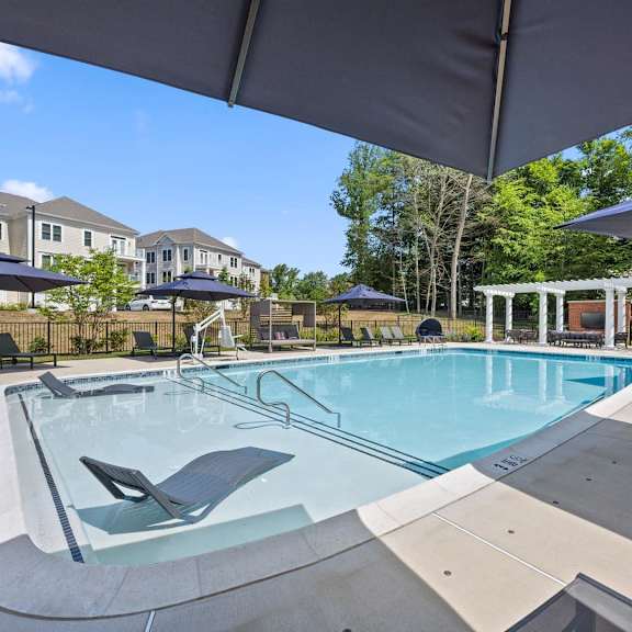 hamilton at eagleview offers a resort-style pool with comfortable seating and umbrellas for relaxation in exton, pa