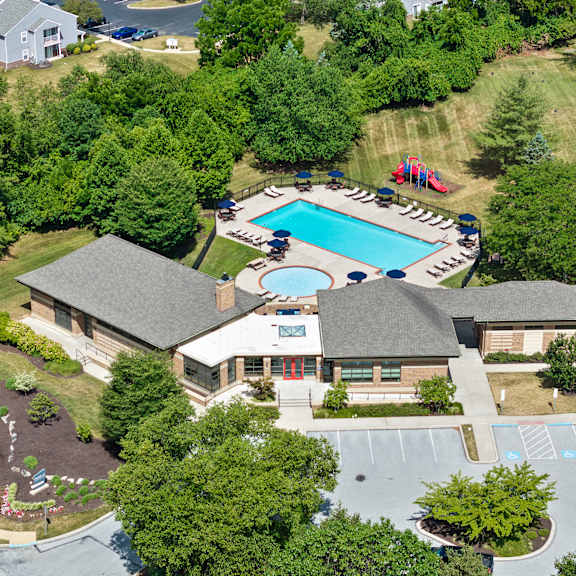 a large house with a pool in the backyard.