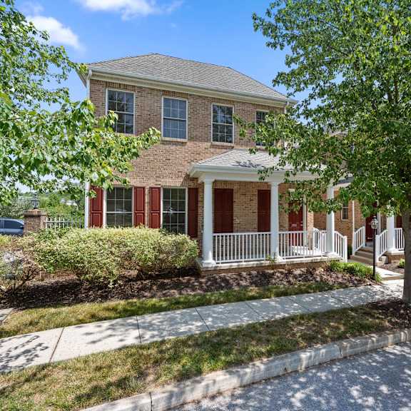 charming house with a red door and white trim, nestled amidst lush greenery at claremont, exton, pa