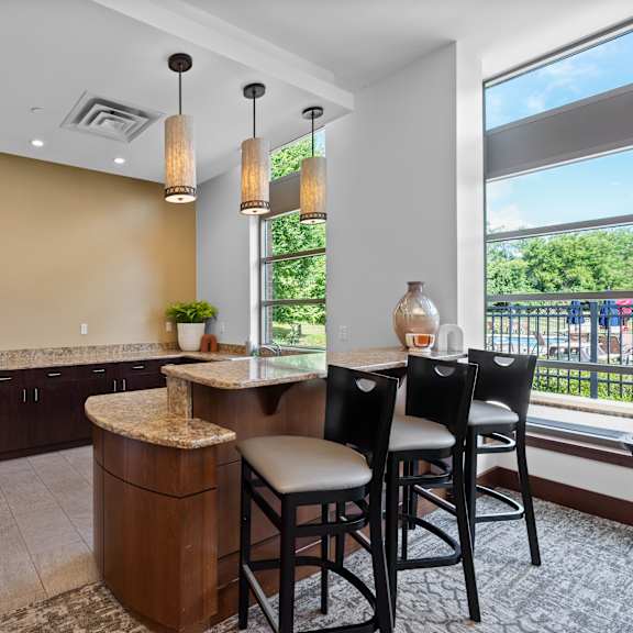a kitchen with brown cabinets and a countertop with a marble top.