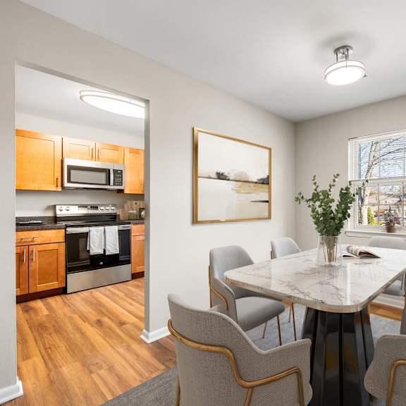 a dining room with a table and chairs.