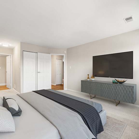 a bedroom with a large bed and a television on a cabinet.