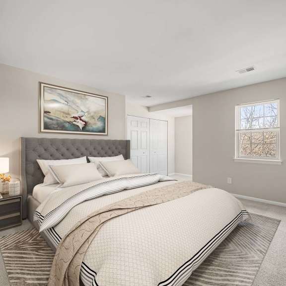 a bedroom with a large bed and a painting on the wall.