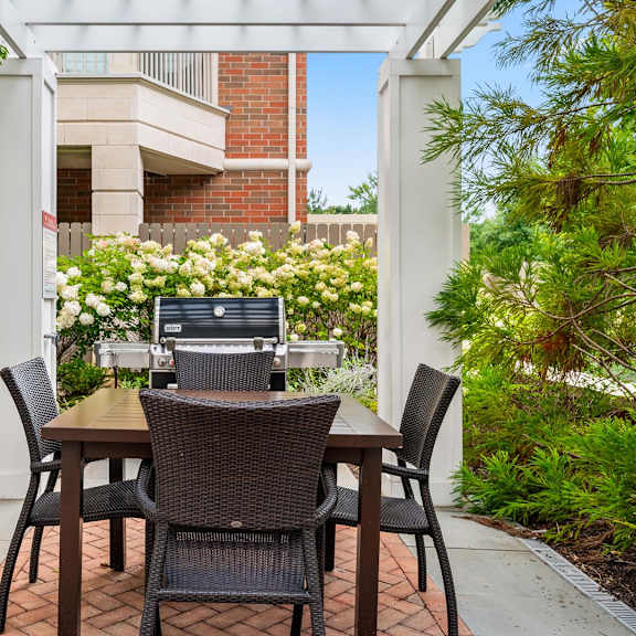 a patio with a table and chairs and a laptop on it.