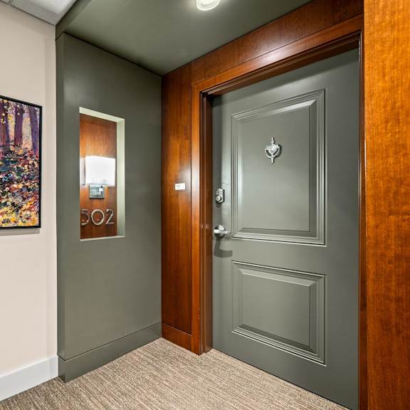 a painting of a woman in a forest is on the wall.