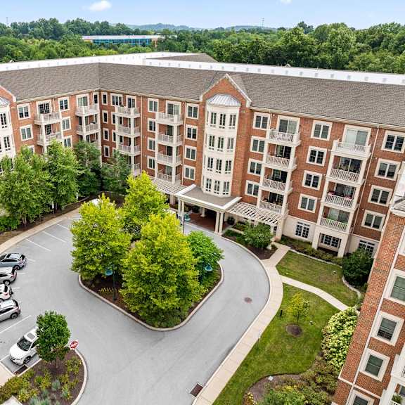 a large building with a parking lot in front of it.