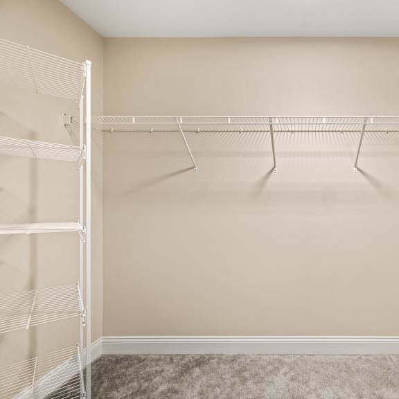 empty room with a white closet rod and hangers.