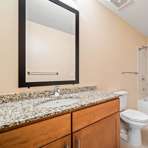 a bathroom with a sink, toilet, and bathtub.