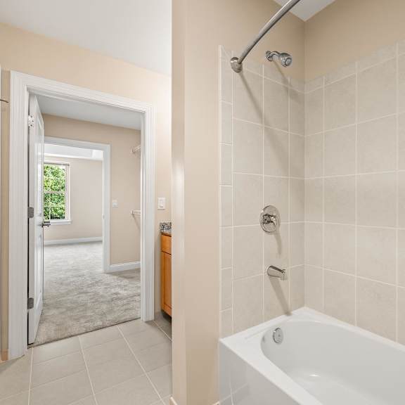 a bathroom with a white tub and a walk in shower.