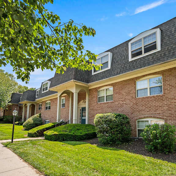 a house with a brick facade and a grey roof.