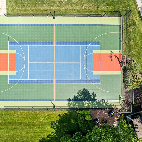 a basketball court with a blue and orange color scheme.