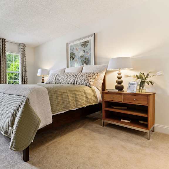 bright and spacious bedroom with two windows, plush carpet flooring, and plenty of natural light in the tahoe floor plan at new kent apartments, west chester, pa