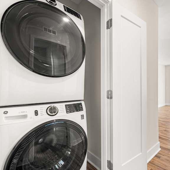 a white washing machine and dryer in a laundry room.