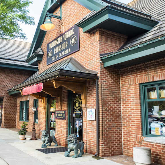 a brick building with a green awning and a sign that says 
