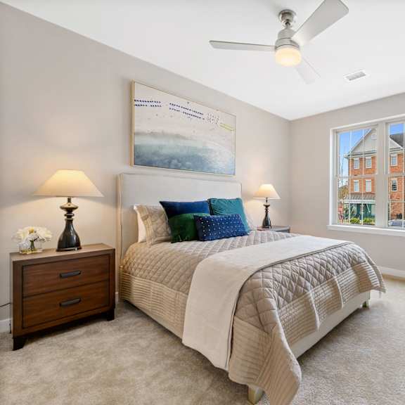 spacious luxury bedroom with soft natural light and a modern ceiling fan, designed for comfortable living at claremont on the square in exton.