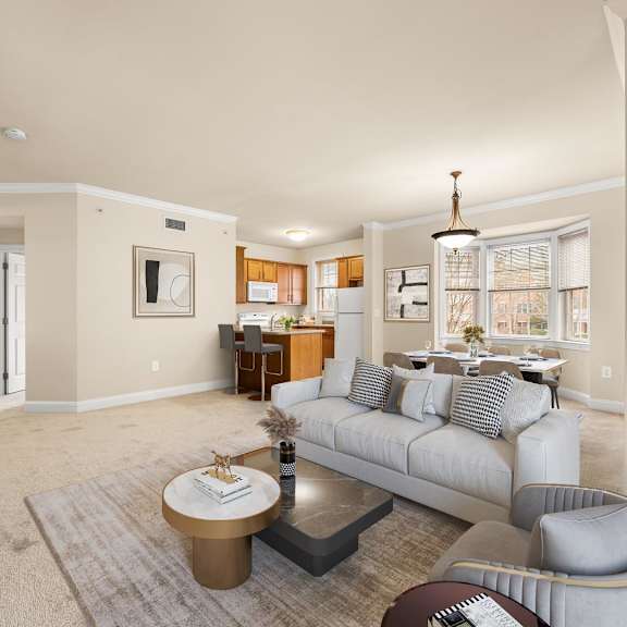 spacious living room with a comfortable grey couch and a chic coffee table at claremont apartments in exton, pa