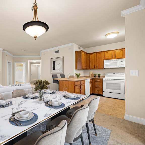 modern dining room with a sleek marble table and stylish grey chairs at claremont apartments in exton, pa