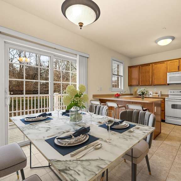 elegant dining room with a table beautifully set for a meal at claremont apartments in exton, pa.