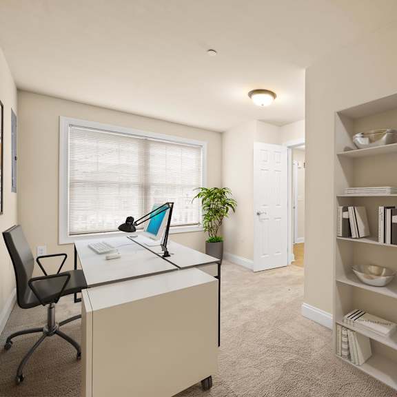 functional room featuring a desk, chair, and bookshelf at claremont apartments in exton, pa