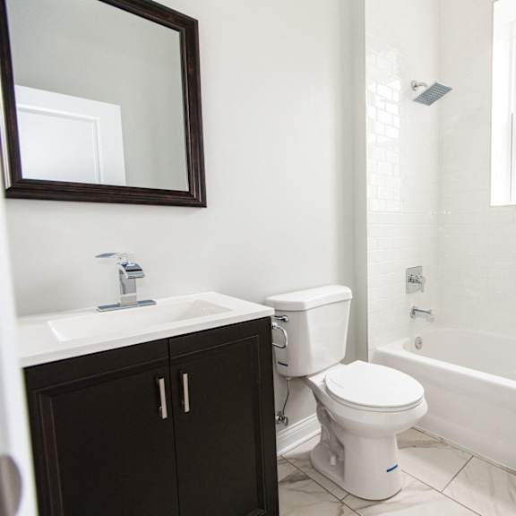 an empty bathroom with a toilet and a sink