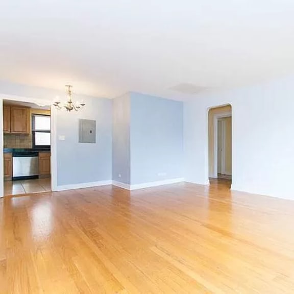 a room with wooden floors and white walls.