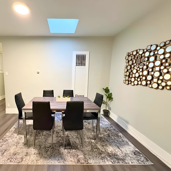 a dining room with a table set for six.